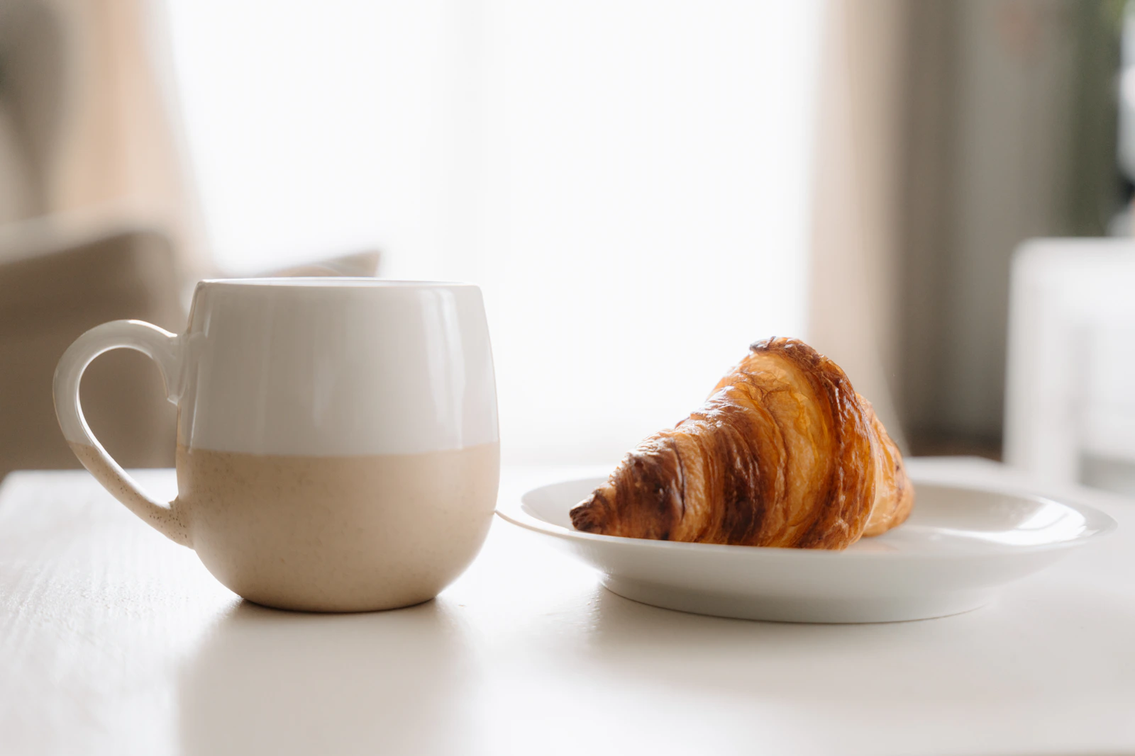 Coffee and a croissant on a cafe table