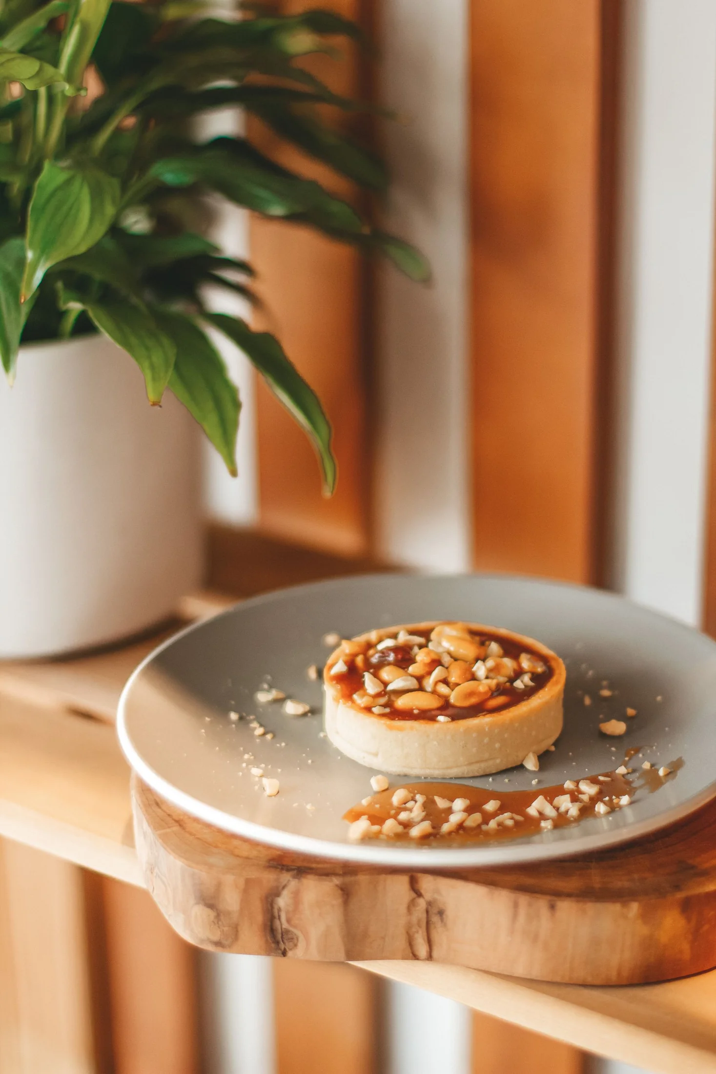 A caramel and nut tart on a grey plate