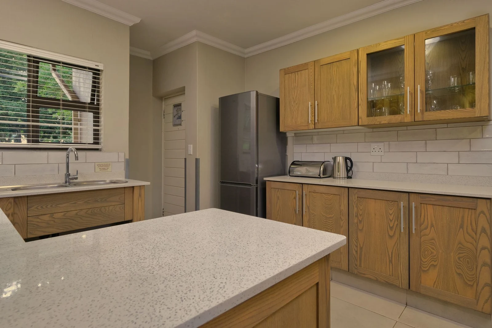 Modern kitchen with wooden cabinets and a light worktop