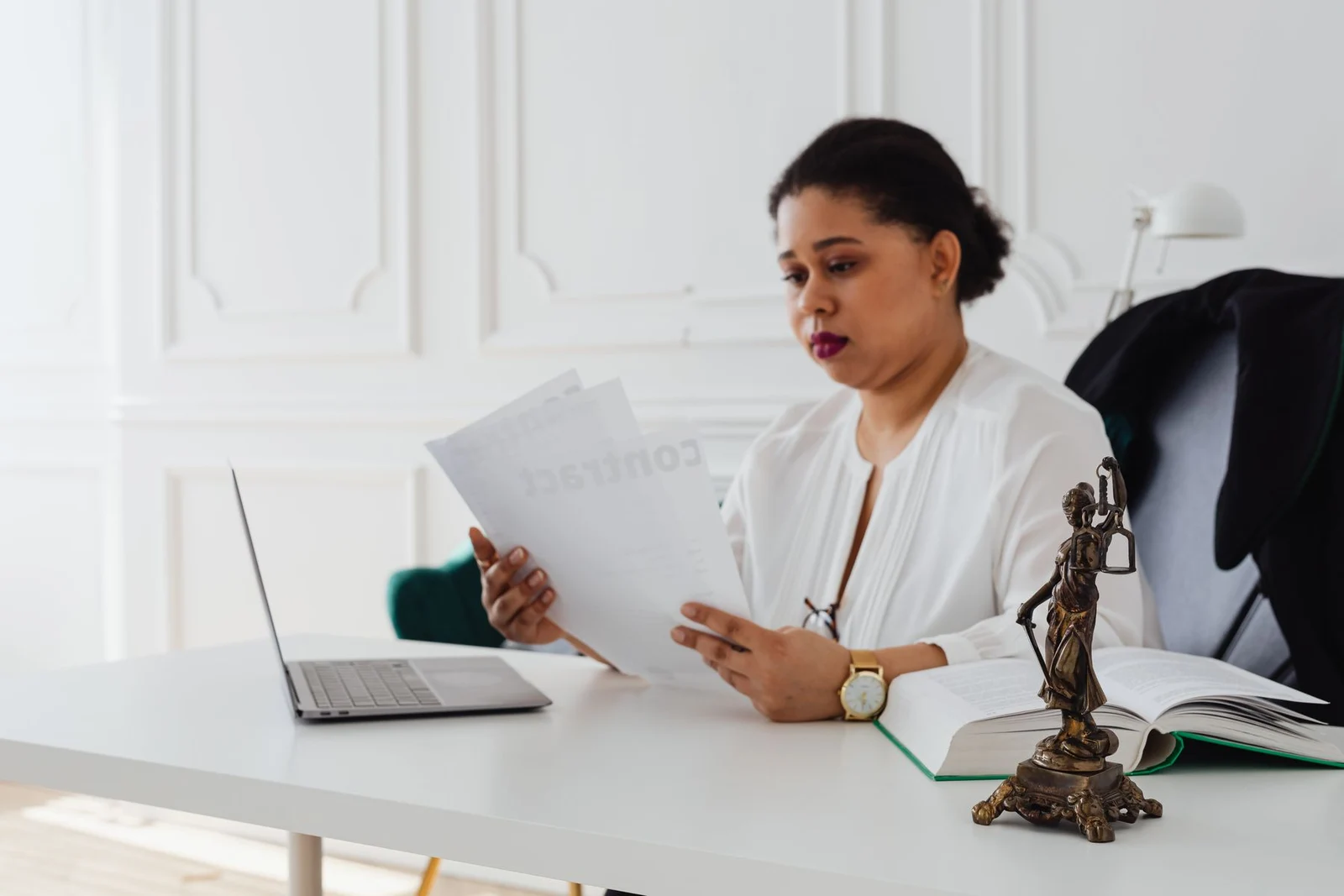 Person reviewing documents at an office desk, illustrative stock photograph