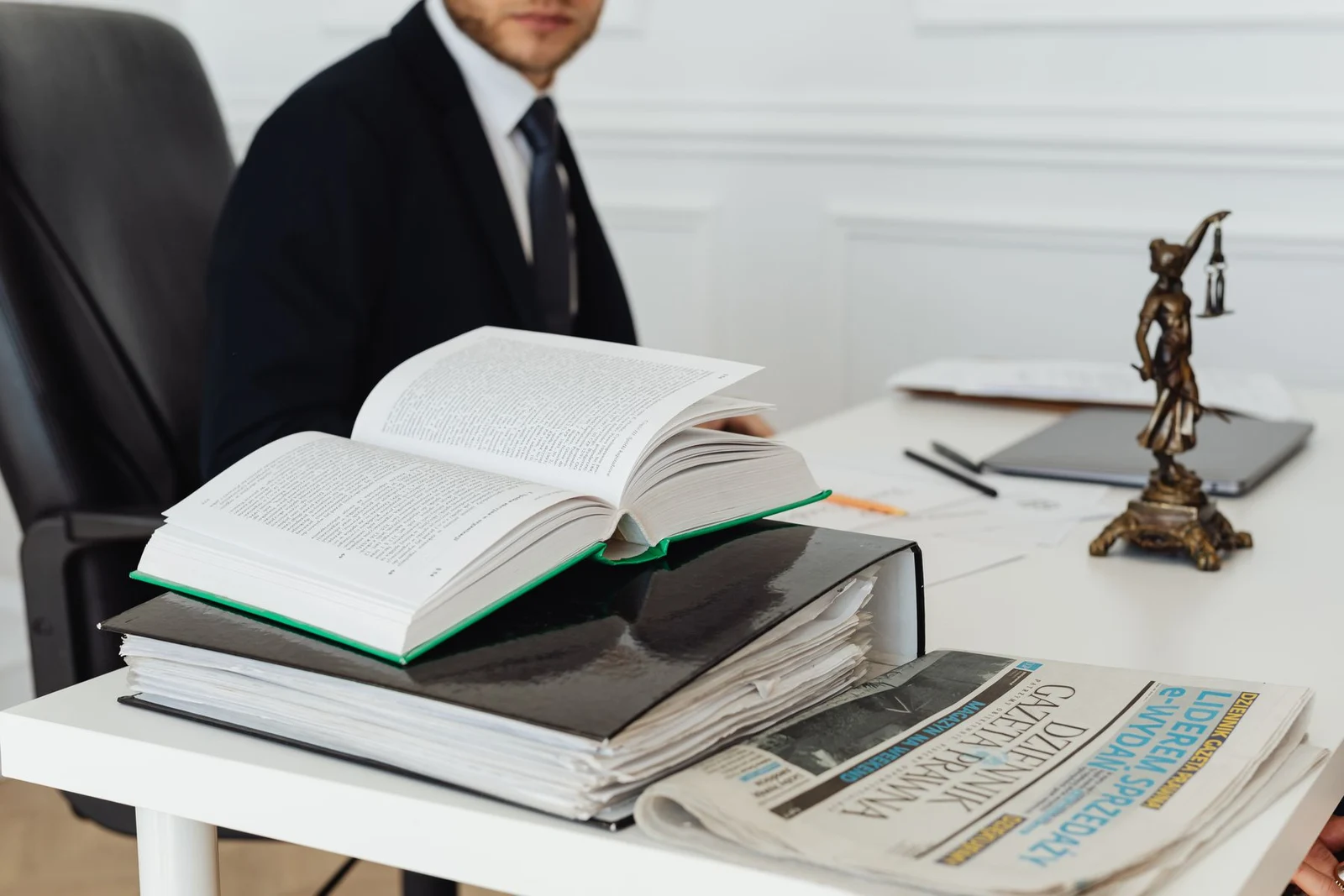 Open reference book and documents on a professional desk