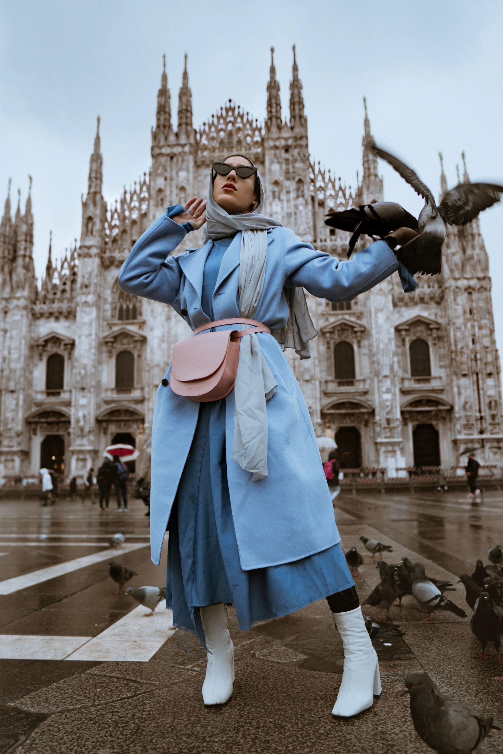 Street-style portrait in a blue coat before a cathedral